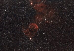 Captured nebula amidst a vast star field, revealing the beauty of space.