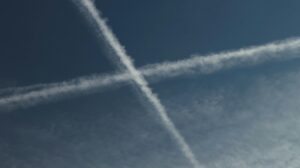 Contrails form an 'X' pattern in the sky, captured over Jönköping, Sweden.